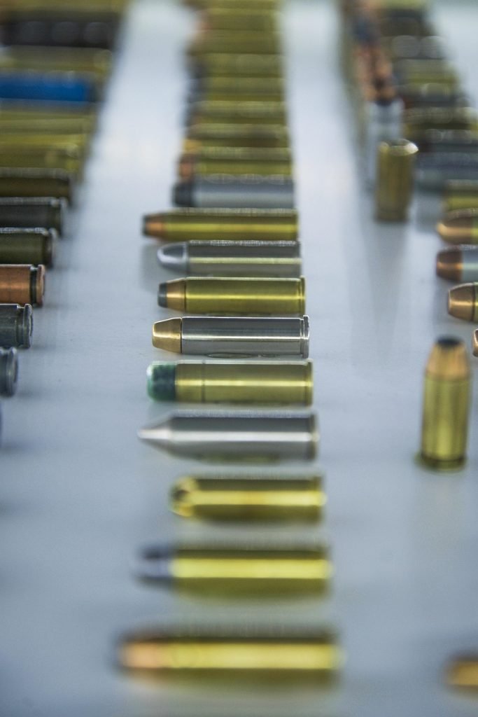 bullet, gold, gun, metal, caliber, weapon, copper, lead, crime, control, ammunition, point, hollow, shooting, handgun, shot, shiny, silver, safety, pistol, trigger, hollowpoint, blue safety, blue metal, blue gun