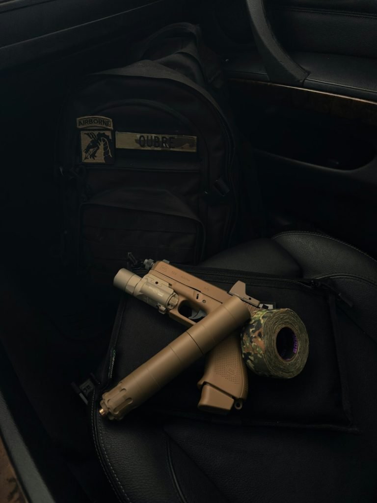 tan-handgun-with-suppressor-and-flashlight-on-seat-wx6elaochbq